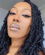 Person with ombré glossy lipstick and butterfly locs.
