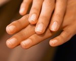 hands with nails wearing sheer nail polish