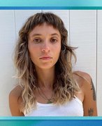 person with micro bangs on blue graphic background