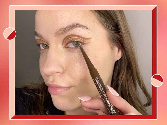 person applying brown eyeliner to lower lash line