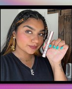 Person holding mascara tube