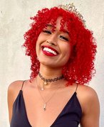 person smiling with red curly hair
