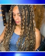 Picture of a person with knotless goddess braids with a blue gradient graphic border.