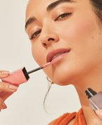 person applying shiny lipstick