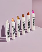A picture of the NYX Professional Makeup Jumbo Multi-Use Highlighter Sticks lined up on a pink background