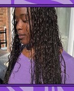 Picture of a person with goddess braids looking down and wearing a purple shirt against a graphic purple background