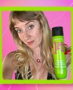 Picture of the editor holding the Matrix Food for Soft Shampoo on a graphic green and pink background