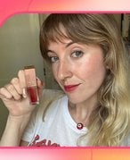 A picture of the editor wearing the Valentino Beauty Liquirosso 2-in-1 Lip & Blush Soft Matte Color on a pink gradient background