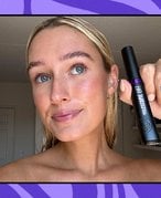 Editor wearing and holding up the L’Oréal Paris Telescopic Lift Washable Color Mascara in Galactic Purple, collaged on a purple background