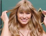 A woman with blonde hair with bangs