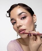 Urban Decay Cosmetics 24/7 Glide-On Lip Pencil and the Maybelline New York Color Sensational Shaping Lip Liner on a multicolored graphic background